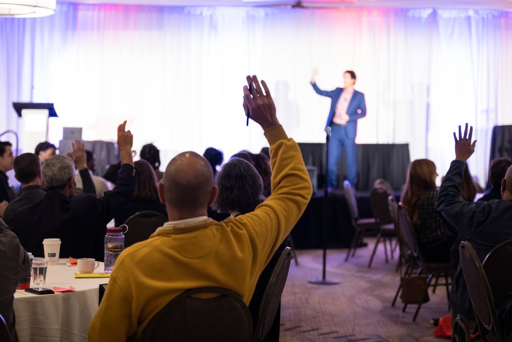 Conference audience with raised hands