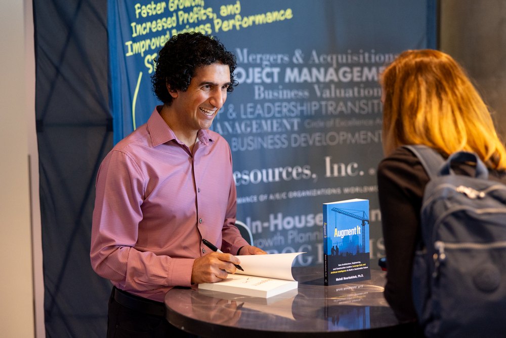Dr. Mehdi signing a copy of his book