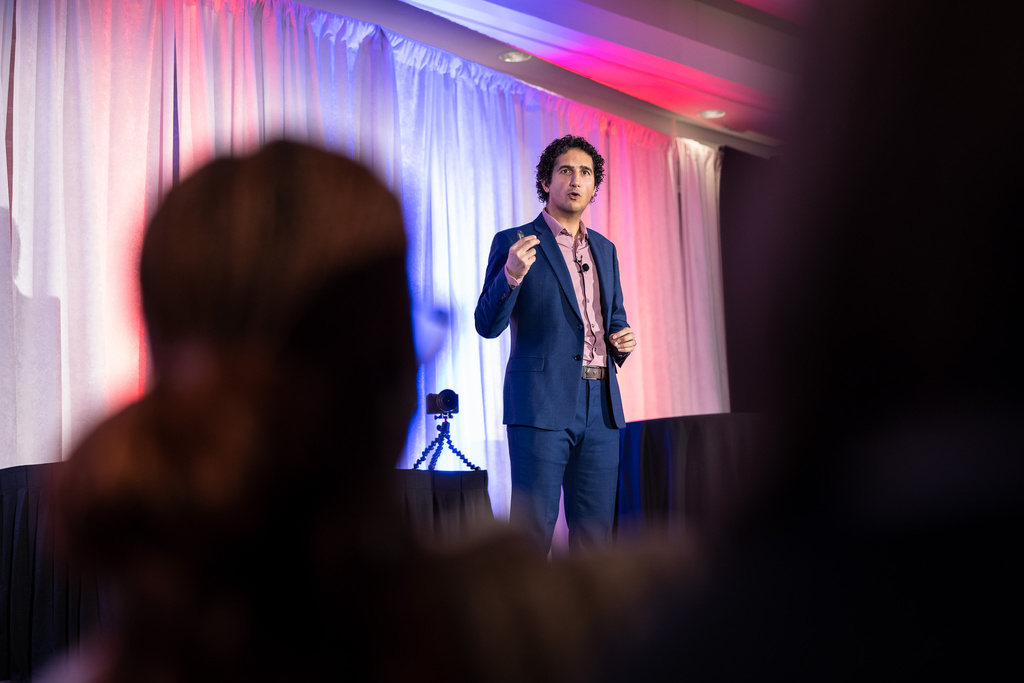 Dr. Mehdi delivering a keynote on stage